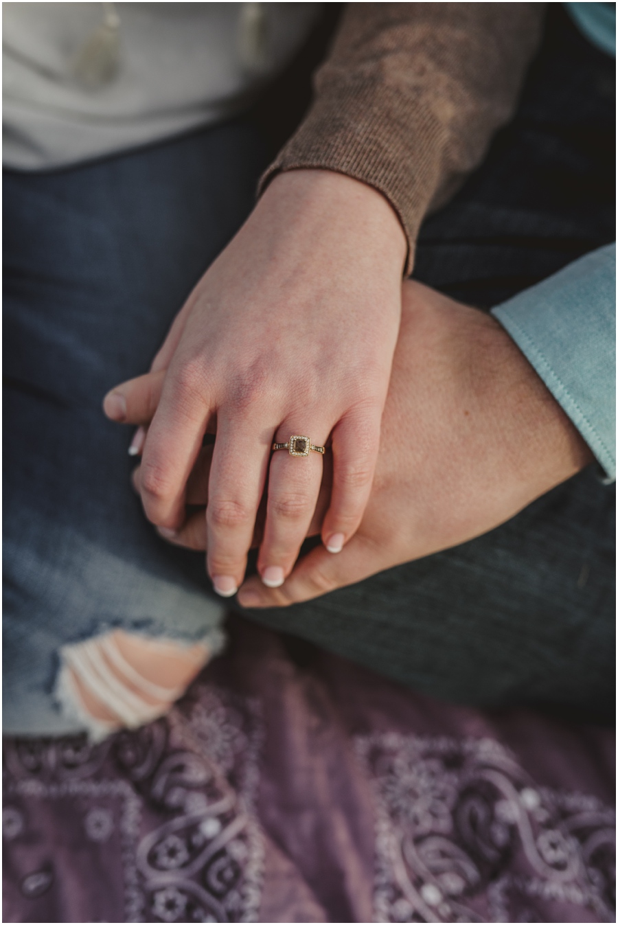 A close up of Emily and Nathan holding hands and of her engagement ring at Meadow Hill Farm.