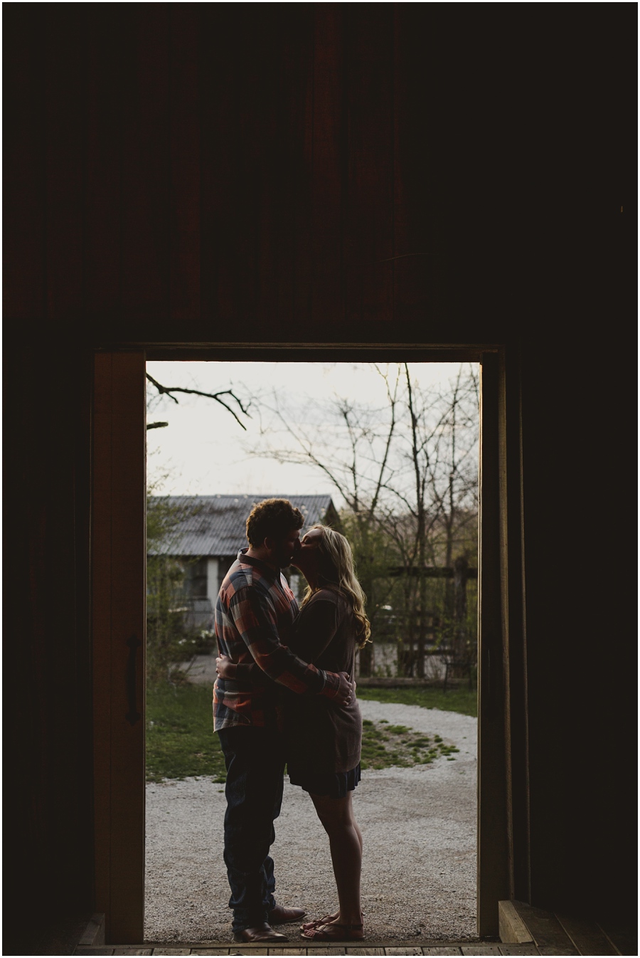 Emily and Nathan silhouetted in the doorway at Meadow Hill Farm.