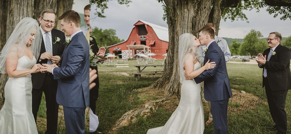 Benji and Ayn Marie exchange rings and kiss during their wedding ceremony at Arrington Vineyards
