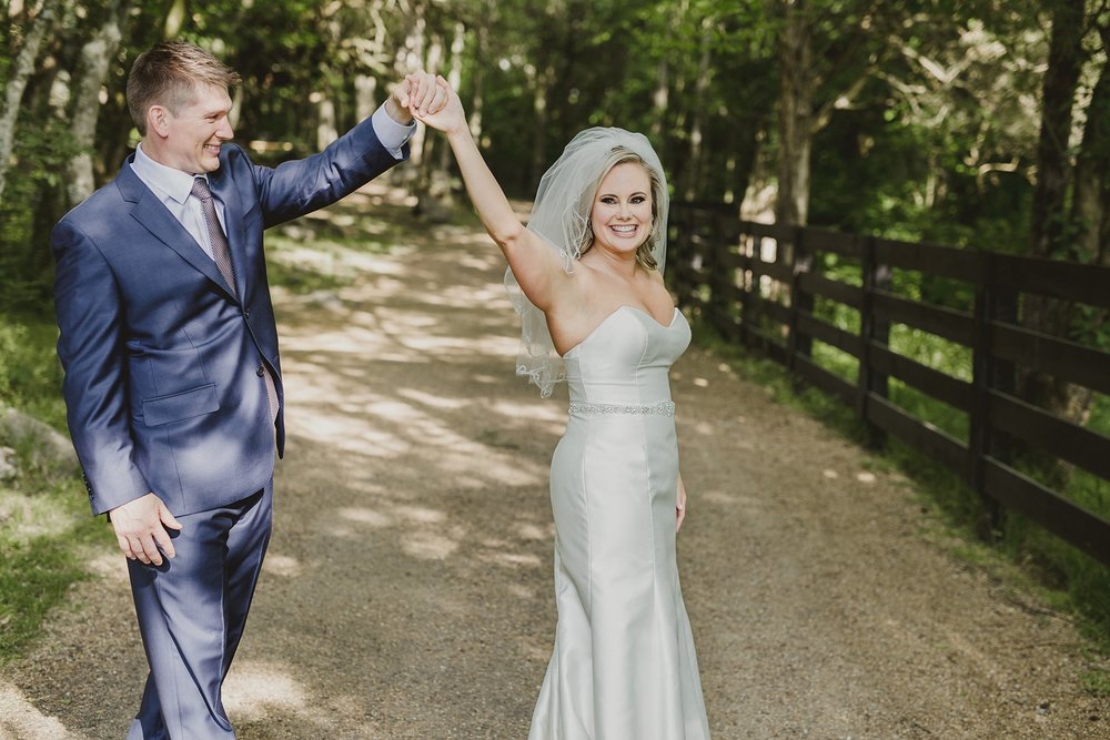 Benji and Ayn Marie during portraits and he is twirling her while she smiles at Arrington Vineyards.