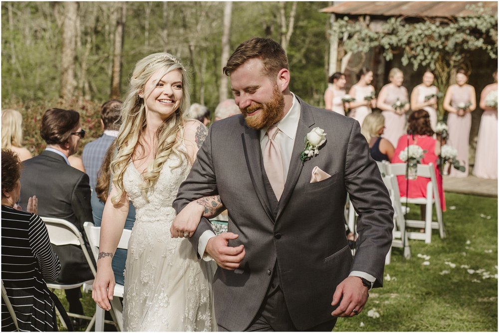 A close up of the bride and groom exiting their ceremony at Evins Mill in Smithville, Tennessee.