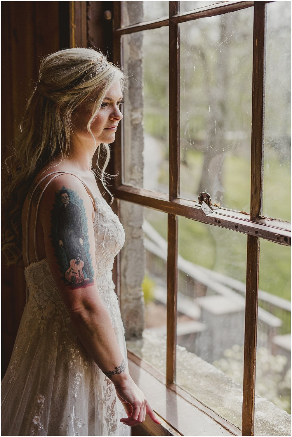 Bride looks out a window at the Evins Mill Wedding Venue.