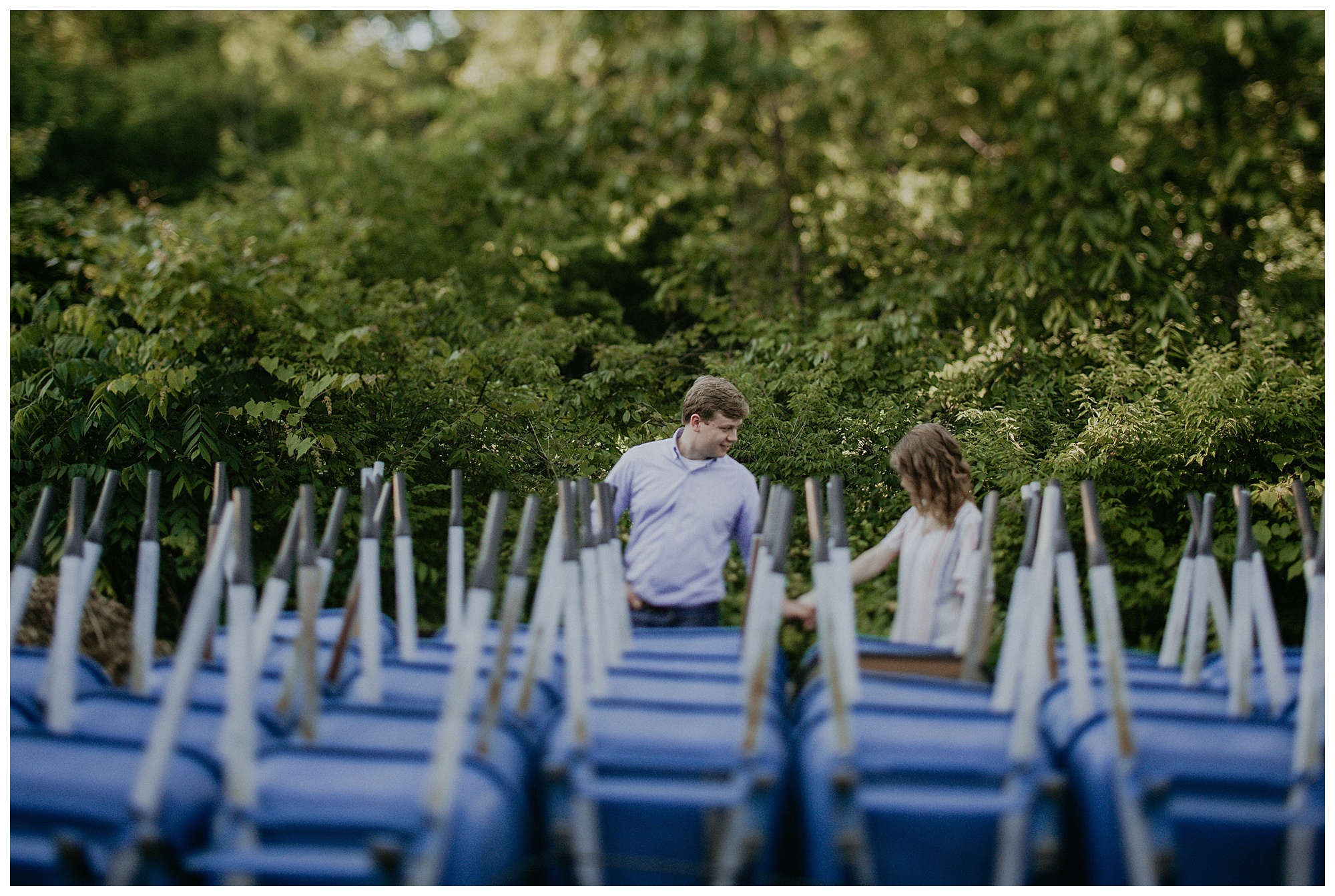 Engaged couple by wheelbarrows at Radnor Park