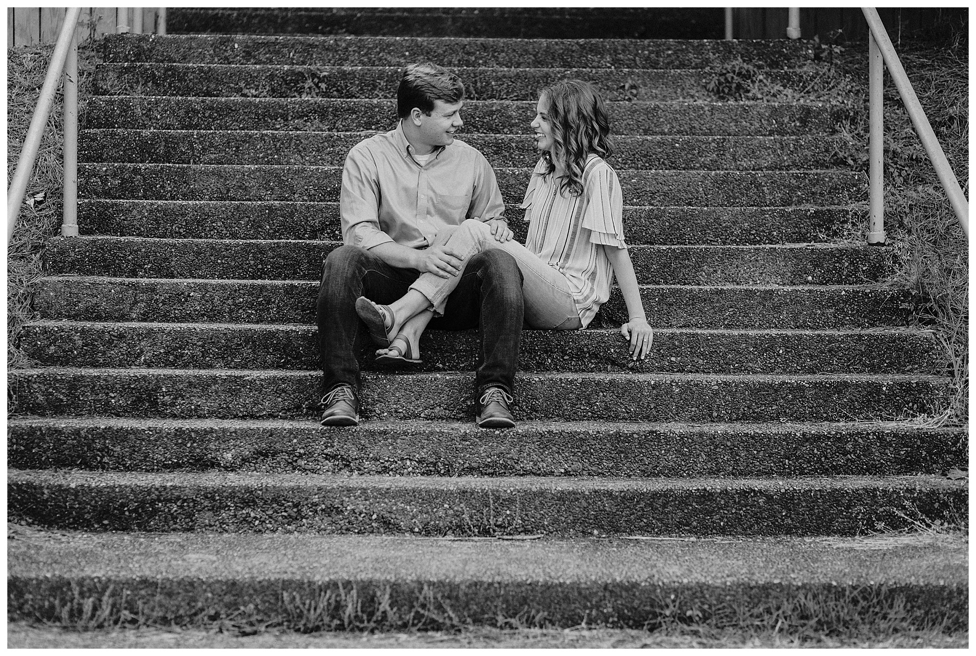 Couple sit on the stairs at Radnor State park and talk
