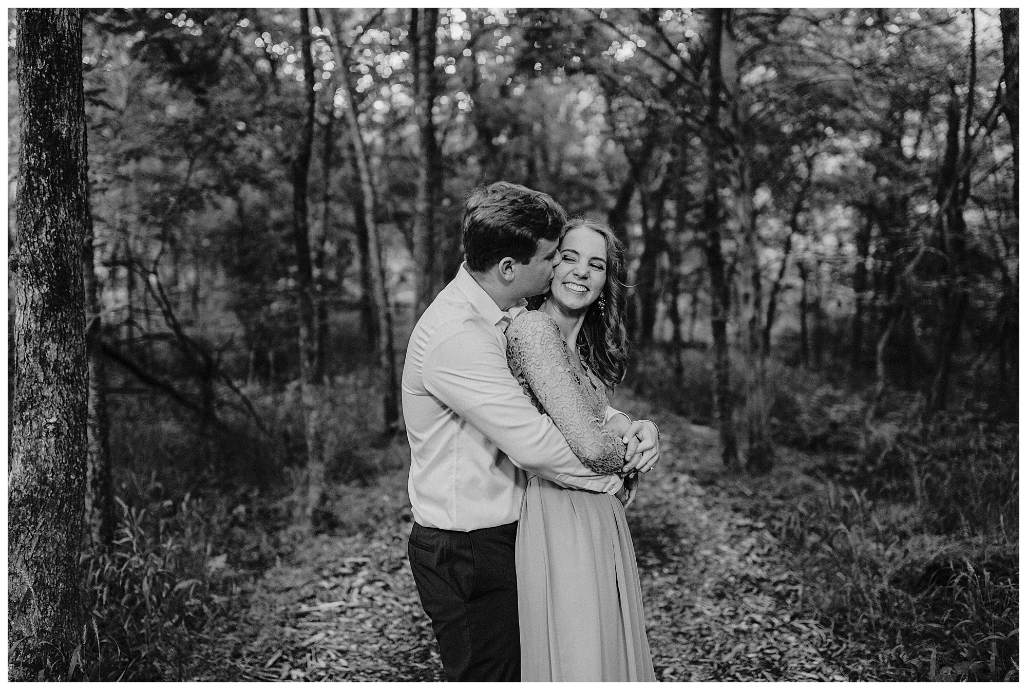 Couple embrace during photos at Radnor State Park