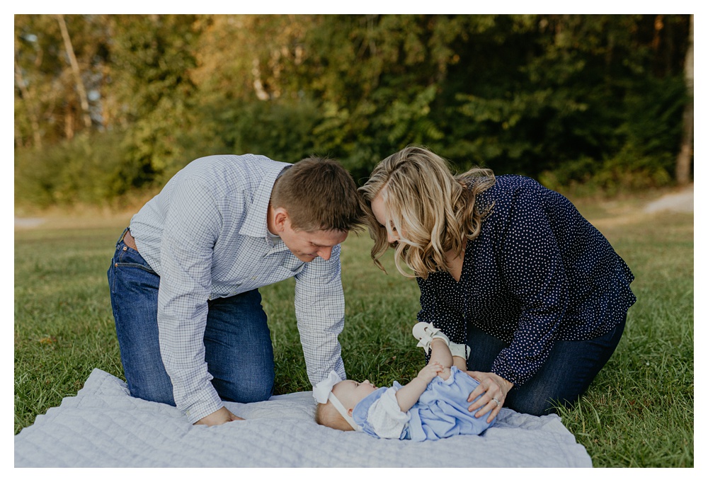 baby girl on blanket with mom and dad by baby's side Arrington Vineyard Family Portraits