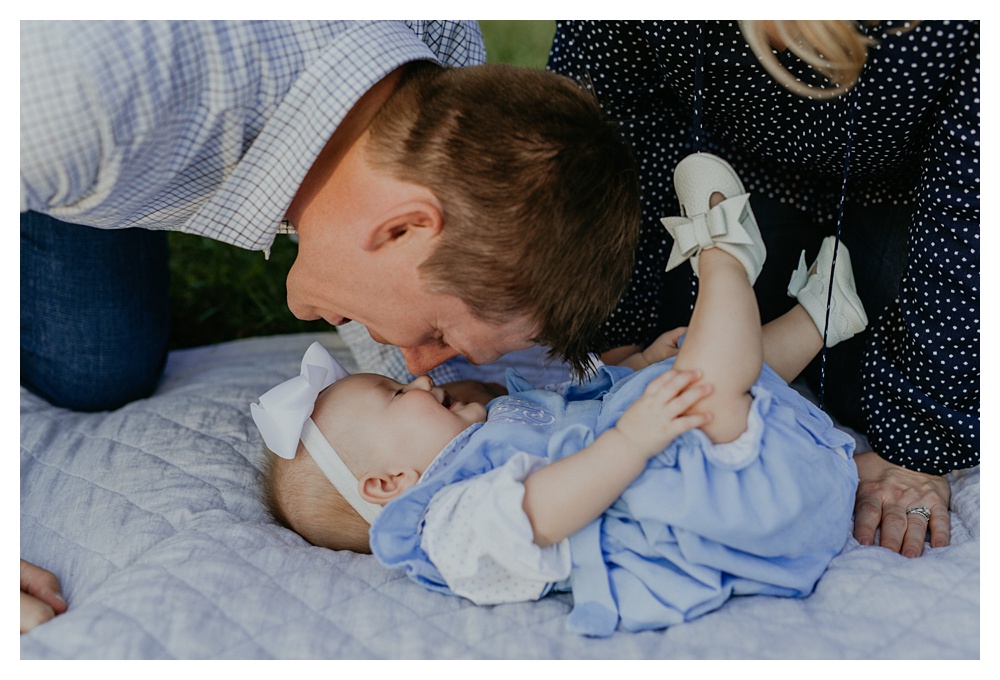 Dad makes baby girl laugh with Eskimo kisses at Arrington Vineyard Family Portraits
