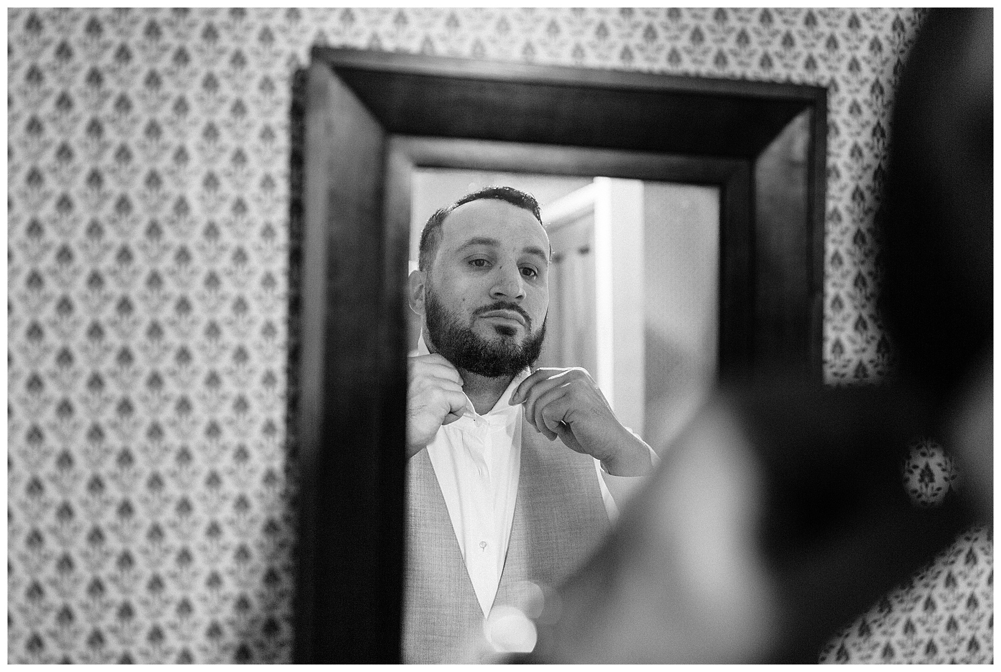 Scott looks at himself in the mirror as he gets ready to marry Lauren at the Cool Springs House.