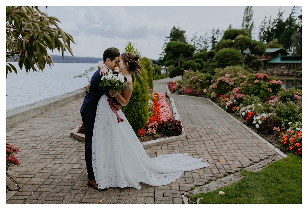 the bride and groom get super close and kiss at their Kiana Lodge in Washington State.