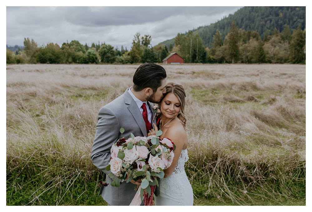 groom kissing bride on side of head, Washington State Wedding Photographer, Mount Peak Wedding Venue, PNW Wedding Photographer