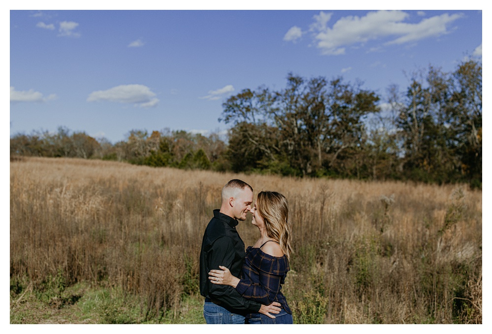 engaged couple in open field