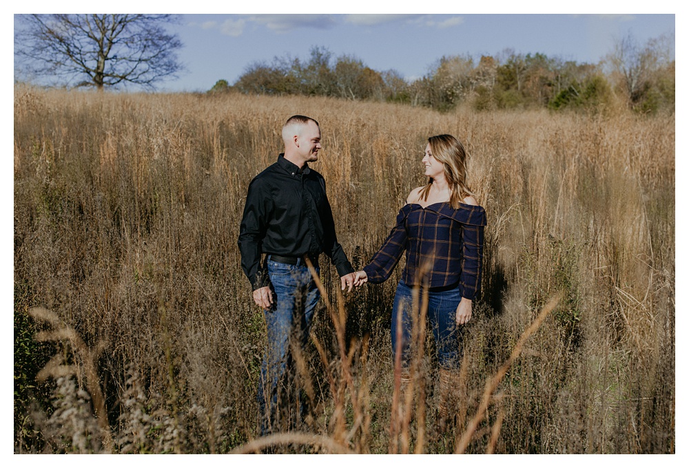 couple in middle of hay field