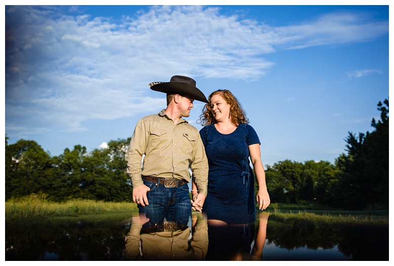 cowboy walks with cowgirl, nashville engagement, nashville engagement photographer, Spring Hill Tennessee, outdoor engagement photos, field engagement photos, cowboy hat, cowboy, western engagement photos, Spring Hill engagement photographer, cowboy and cowgirl, summer engagement photos