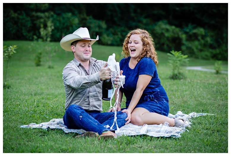 champagne bottle bubbles over, nashville engagement, nashville engagement photographer, Spring Hill Tennessee, outdoor engagement photos, field engagement photos, cowboy hat, cowboy, western engagement photos, Spring Hill engagement photographer, cowboy and cowgirl, summer engagement photos
