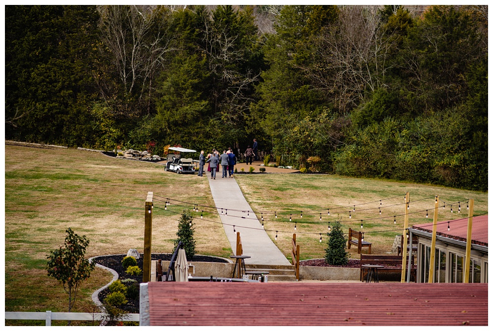 a distant view of the bridal party walking to the ceremony site, nashville wedding photographer, nashville wedding, nashville Tennessee wedding, intimate wedding, Drakewood Farm, intimate nashville wedding, intimate outdoor wedding, intimate backyard wedding, intimate elopement, Tennessee elopement
