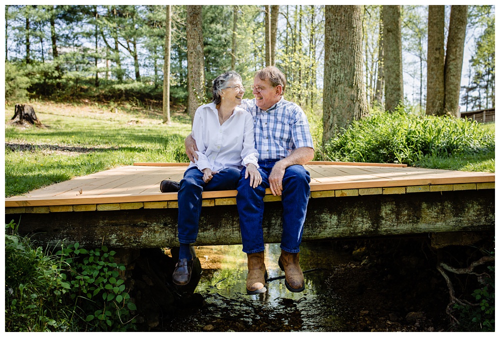 Husband and wife sit on a bridge together, nashville family photographer, family pose ideas, photo clothing ideas, what to wear for photos, best Nashville family photographer, best Nashville Photographer, Nashville's best portrait photographer, experienced nashville family photographer
