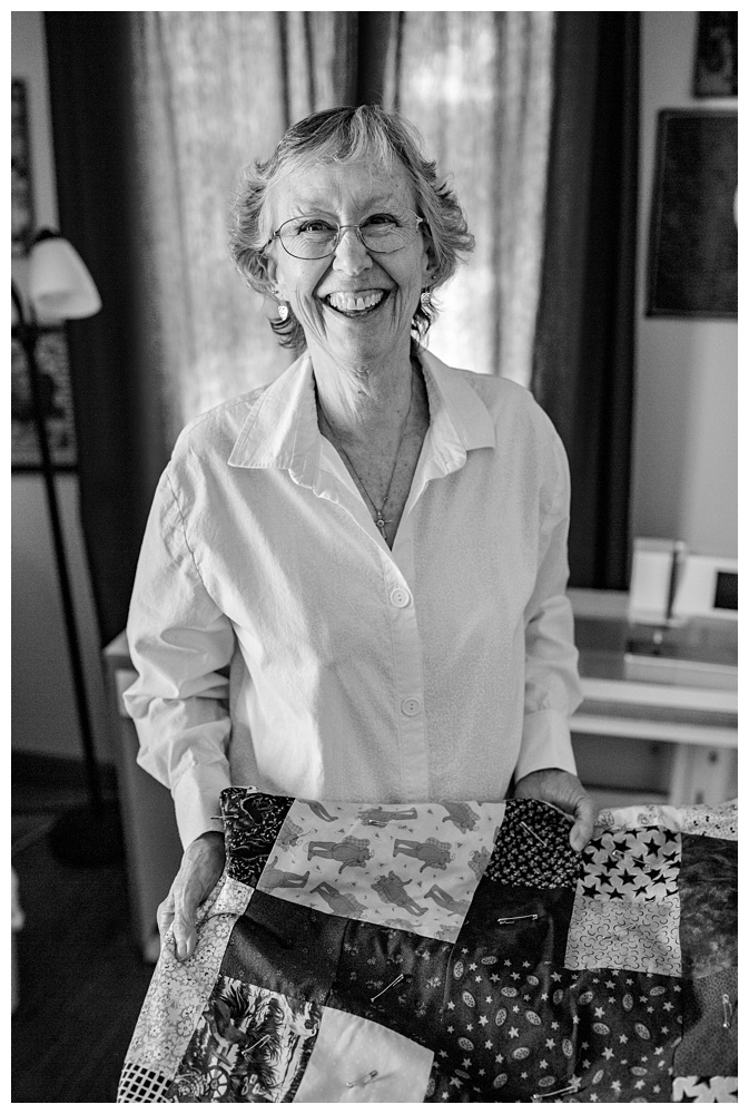 a woman showing me her quilt while smiling, nashville family photographer, family pose ideas, photo clothing ideas, what to wear for photos, best Nashville family photographer, best Nashville Photographer, Nashville's best portrait photographer, experienced nashville family photographer