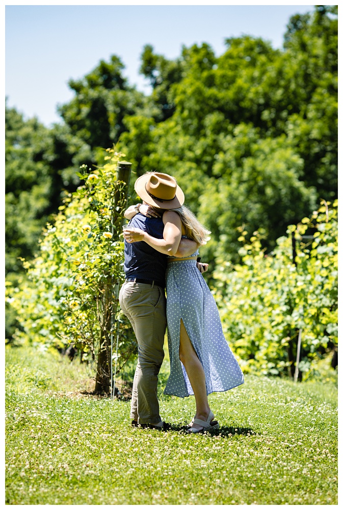 Woman hugs her boyfriend after he proposes and she says yes, nashville proposal photographer, surprise proposal, arrington vineyards, Tennessee winery, best surprise proposal photographer, best Nashville Photographer, best Nashville proposal photographer, Tennessee photographer, couples photographer,