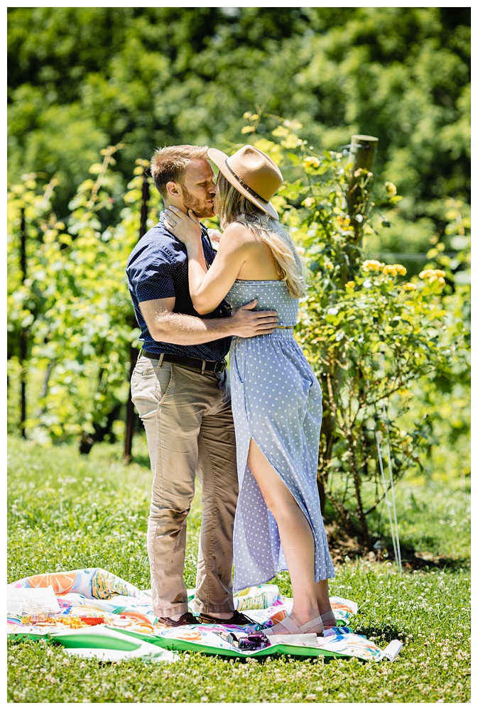 girlfriend kisses her boyfriend after he proposes to her and she says yes, nashville proposal photographer, surprise proposal, arrington vineyards, Tennessee winery, best surprise proposal photographer, best Nashville Photographer, best Nashville proposal photographer, Tennessee photographer, couples photographer,