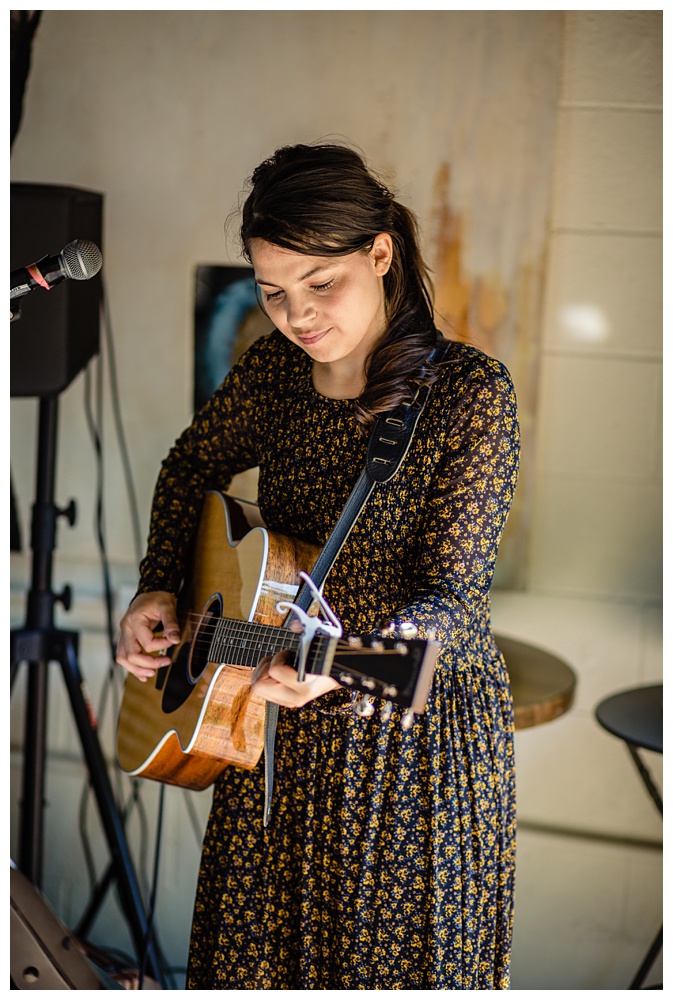 a woman playing guitar at Miel Restaurant