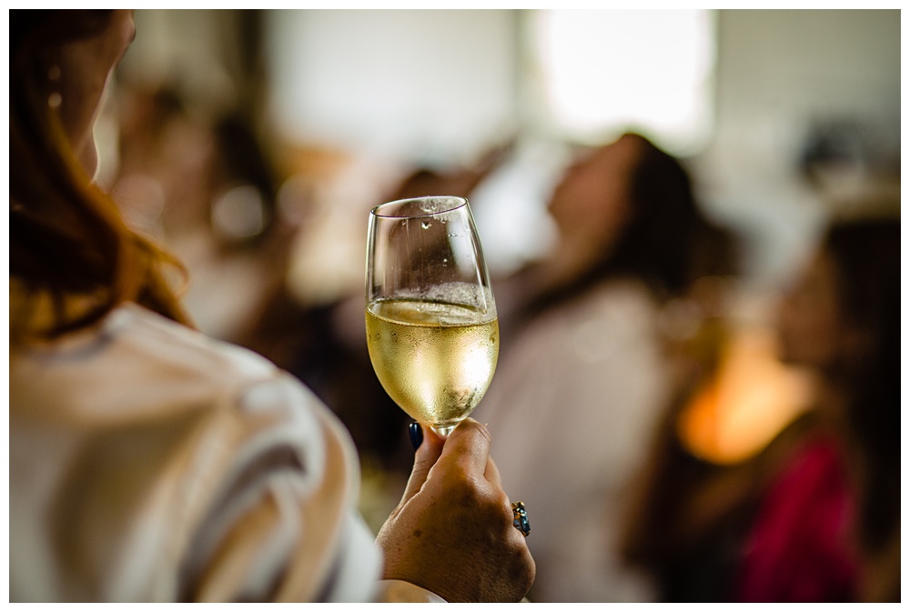 Nashville Event Photographer, Nashville Celebrity Event, Miel Restuarant, Nashville Food Photographer, Places to have a party in Nashville, Places to host a party in Nashville, Nashville Brunch Places, Luxury Nashville Restaurants, a woman holding a glass of wine making a toast