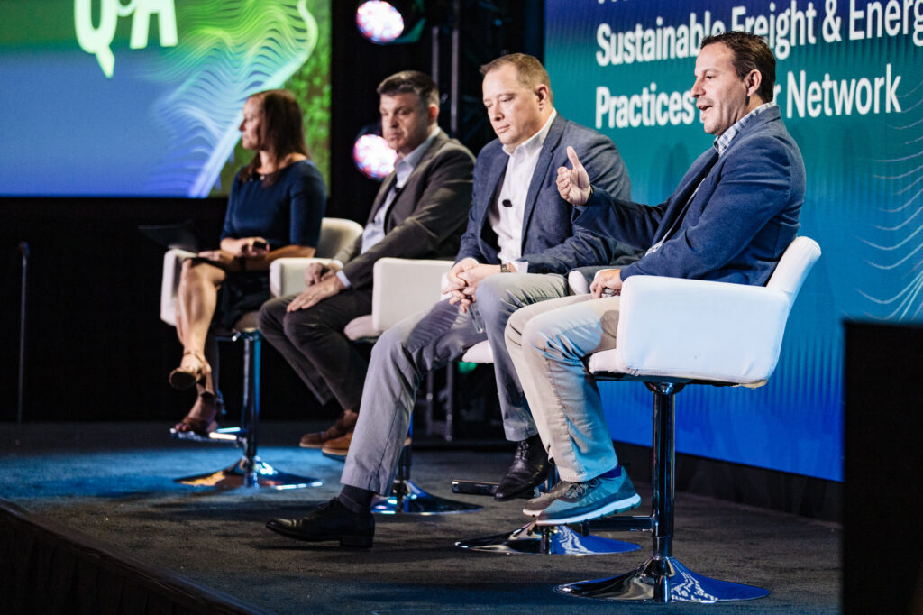 a panel of speakers on a stage.