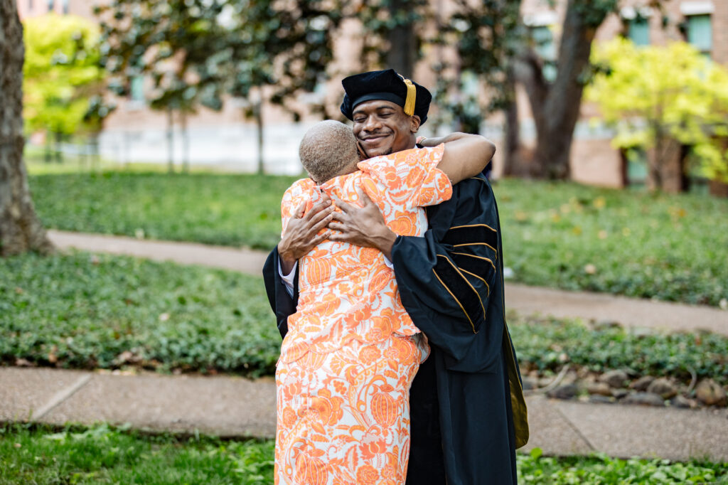 a grandson graduating college hugging his grandmother.